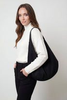 Elegant black suede Lumina Victoria hobo handbag with multiple pockets, stylish and spacious for everyday carry.