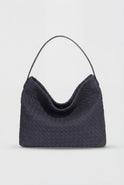 Elegant black suede tote bag by Lumina Wear featuring a spacious design and structured shape for versatile use.