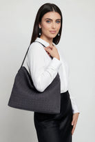 Elegant black suede tote bag by Lumina Wear, featuring a spacious design and stylish craftsmanship for everyday use.