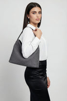 Elegant black suede tote bag by Lumina Wear, featuring a spacious design and stylish hand-held carry.