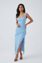 Elegant blue evening maxi dress by Lumina Wear featuring a high slit, fitted bodice, and flowing fabric for formal occasions.