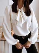 Green Victoria women's blouse by Lumina Wear featuring a bow tie front and puffed sleeves, elegant and stylish for women.