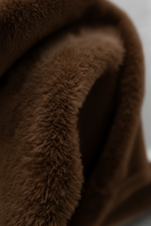 Elegant brown turtleneck sweater from Lumina Wear featuring a slim fit, styled on a model for a sophisticated look.