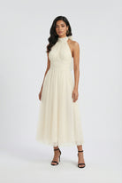 Elegant cream midi dress by Lumina Wear with a flowy design, showcased on a model in a stylish, feminine silhouette.