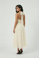 Elegant cream midi dress by Lumina Wear featuring a flowy design, perfect for stylish occasions.