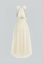 Elegant cream midi dress by Lumina Wear featuring a flowy design, perfect for sophisticated occasions.