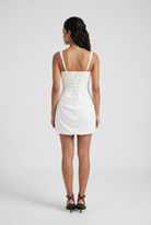 White Victoria Lumina Wear women's mini dress with elegant draped design and hourglass silhouette, perfect for stylish occasions.