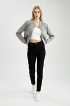 Elegant gray Lumina Wear bomber jacket with timeless design, shown on a hanger with a sleek, modern silhouette.