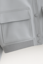 Elegant gray bomber jacket from Lumina Wear featuring a timeless design and stylish fit, shown in a close-up image.