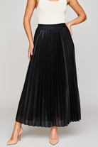 Gold high-waist pleated maxi skirt by Lumina Wear, elegant and flowing, showcased in a stylish fashion photo.