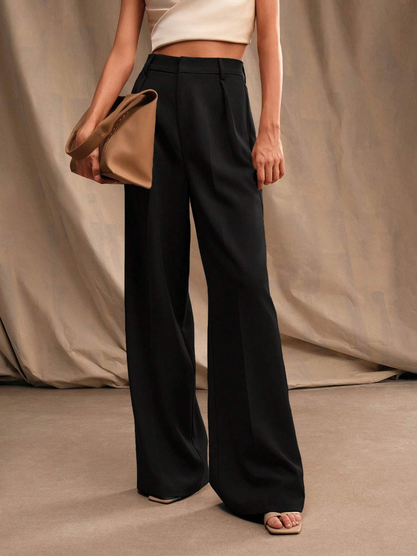 Black Victoria Lumina Wear high waist wide leg trousers, stylish and elegant with a flattering fit, shown on a model.