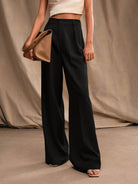 Black Victoria Lumina Wear high waist wide leg trousers, stylish and elegant with a flattering fit, shown on a model.