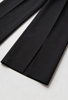 Victoria Lumina high-waisted black women's trousers with pleats, tailored fit, and sleek style for a sophisticated look.