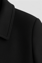 Elegant lightweight black windbreaker jacket by Lumina Wear, featuring a flattering fit and stylish design.