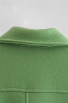 Lumina Wear Victoria elegant green long sleeve jacket with button closure, stylish and tailored for a sophisticated look.