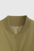 Olive green Lumina Wear Victoria bomber jacket with elegant, timeless design, displayed on a mannequin.
