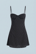 Black Victoria Lumina Wear open-back polka dot mini dress with frill hem, stylish women's dress perfect for elegant occasions.