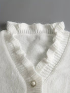 Elegant women's blouse by Lumina Wear featuring ruffle design and decorative buttons, displayed on a model.