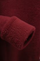 Lumina Wear Victoria burgundy slim fit turtleneck sweater, elegant knit design, close-up of the cozy, stylish sweater fabric.