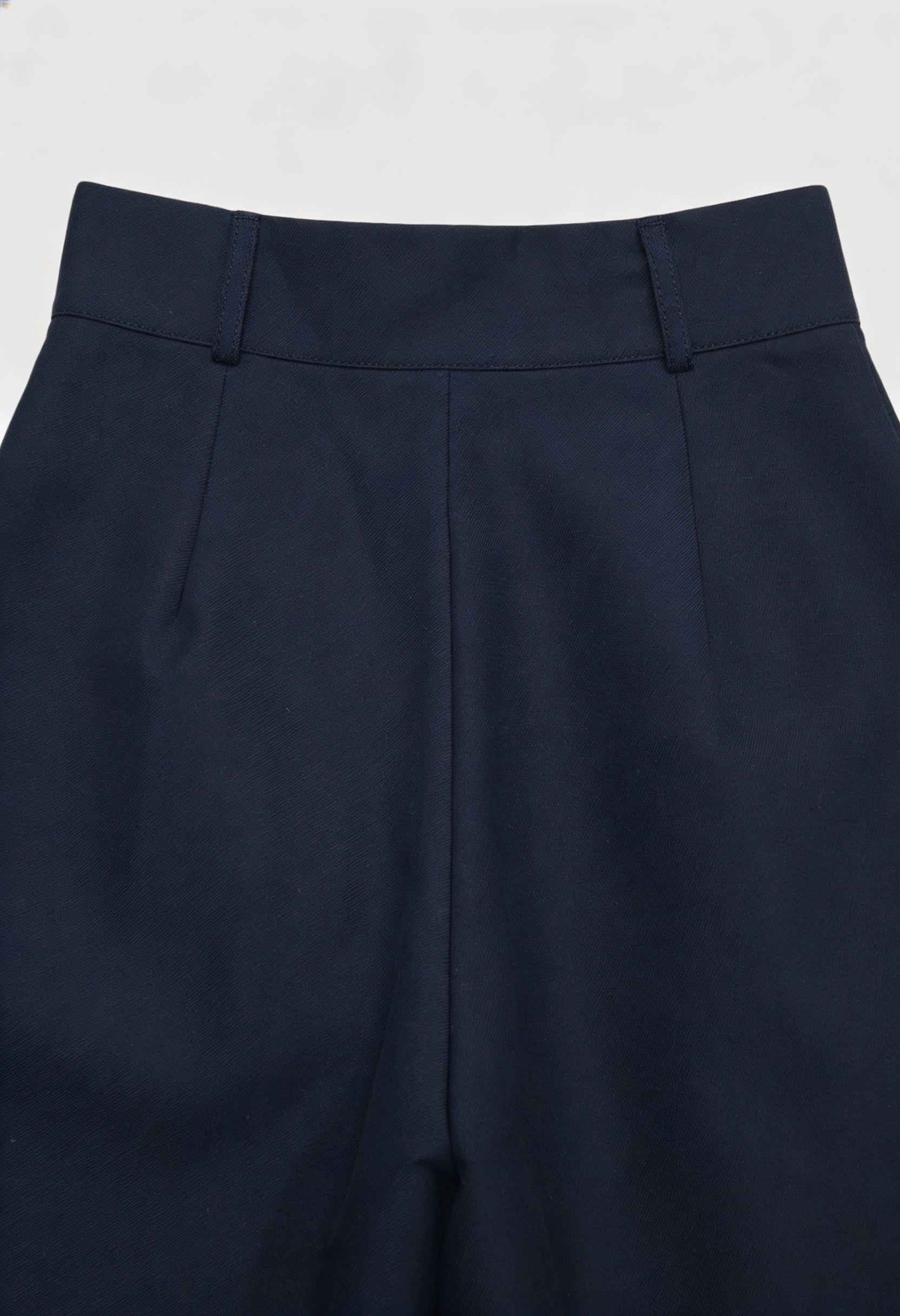 Navy blue Victoria Lumina Wear wide-leg trousers with stretch fabric, shown on a model highlighting their elegant, comfortable fit.