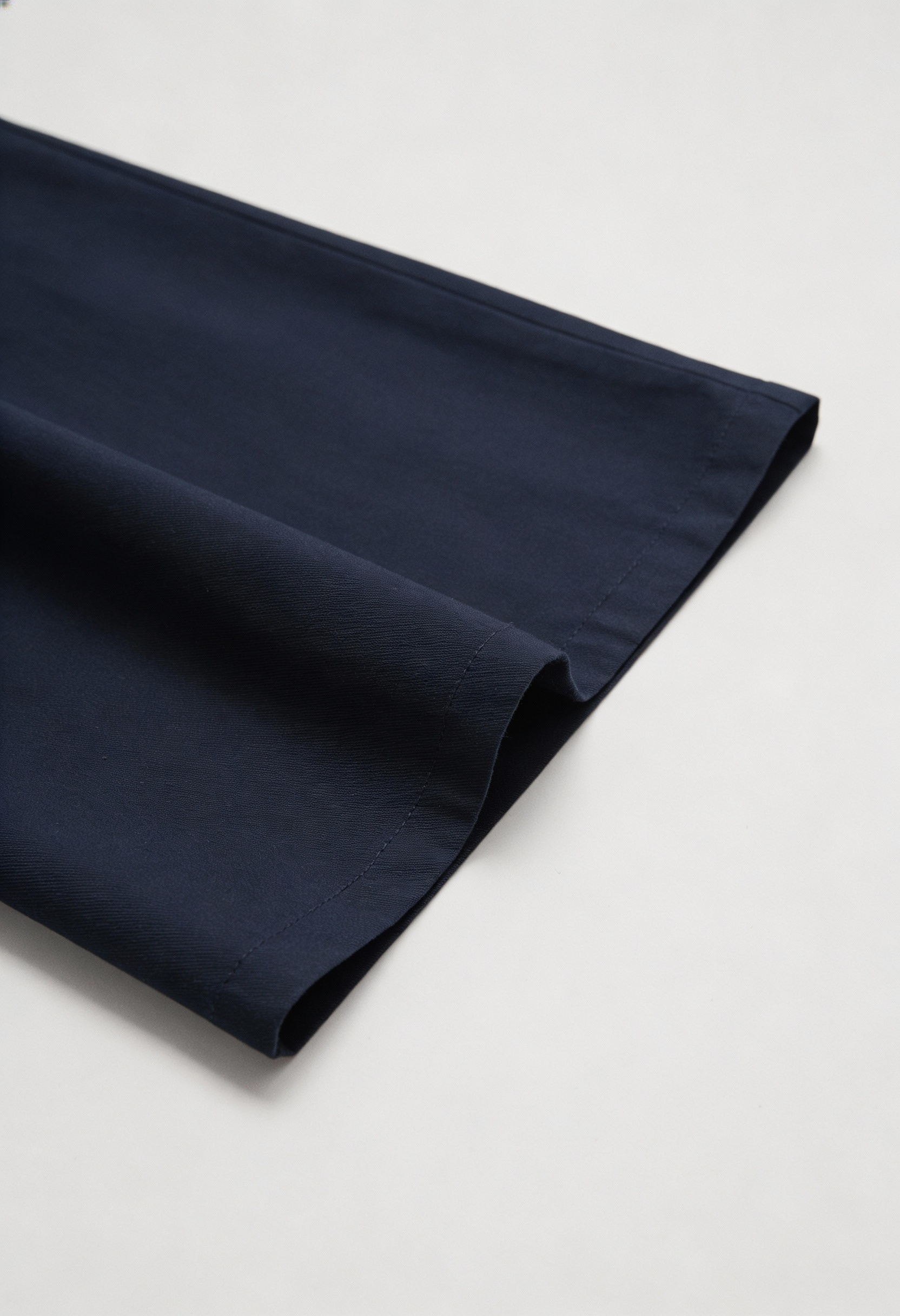 Navy blue Victoria Lumina Wear wide-leg trousers with stretch fabric, shown on a model, showcasing a relaxed yet elegant fit.