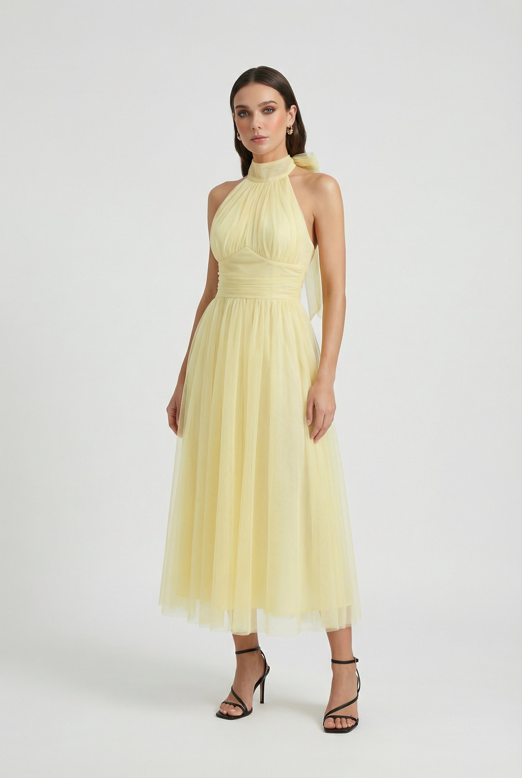 Elegant yellow midi dress with high neck design by Lumina Wear, styled on a woman, perfect for sophisticated occasions.