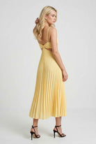 Yellow flowing pleated dress by Lumina Wear featuring an elegant silhouette for women.