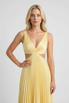 Victoria yellow pleated dress by Lumina Wear, flowing elegant silhouette for women's fashion, displayed on a model.