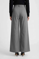 Gray Victoria Lumina Wear high-waist palazzo pants for women, flowy and stylish, shown on a model in a natural pose.