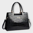 Black Victoria Lumina glossy crocodile pattern handbag with structured design, showcasing elegant craftsmanship and textured finish.
