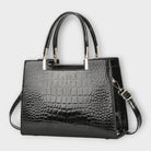 Black Victoria glossy crocodile pattern handbag by Lumina Wear featuring a structured design and elegant craftsmanship.