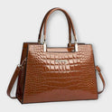 Lumina Victoria glossy crocodile pattern handbag with structured design in black, featuring sleek, elegant craftsmanship.