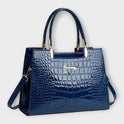 Black Victoria Lumina glossy crocodile pattern handbag with structured design and top handles, stylish and elegant for everyday use.