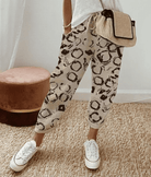 Lightweight beige casual trousers with relaxed fit from Lumina Wear, featuring a subtle printed pattern and comfortable design.