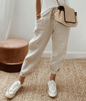 Lightweight beige casual trousers with relaxed fit from Lumina Wear, featuring subtle print details.