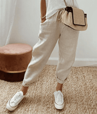 Light beige Lumina Wear Victoria casual trousers with a relaxed fit, lightweight fabric, and subtle print detail.