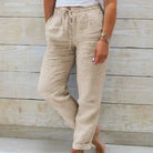 Lightweight beige summer trousers with elastic waist from Lumina Wear, shown as relaxed-fit pants ideal for warm weather.