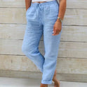Light beige lightweight summer trousers with elastic waist by Lumina Wear, shown on a model.