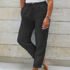 Lightweight beige summer trousers with elastic waist from Lumina Wear, shown flat with open front and relaxed fit.