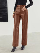 Victoria Lumina women's slim fit black leather trousers with soft finish, shown on a model. Stylish and form-fitting design.