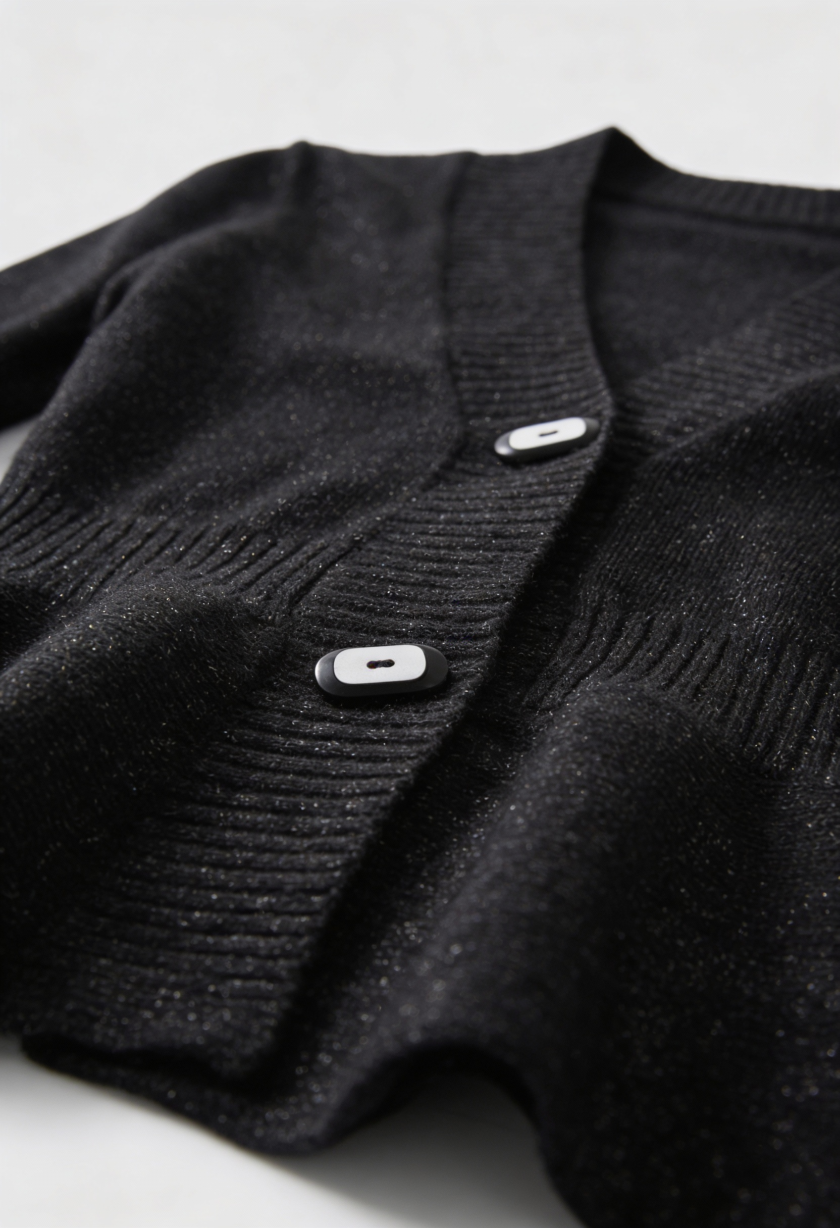 Lumina Wear Victoria black cardigan sweater with open front design, soft knit fabric, styled casually.
