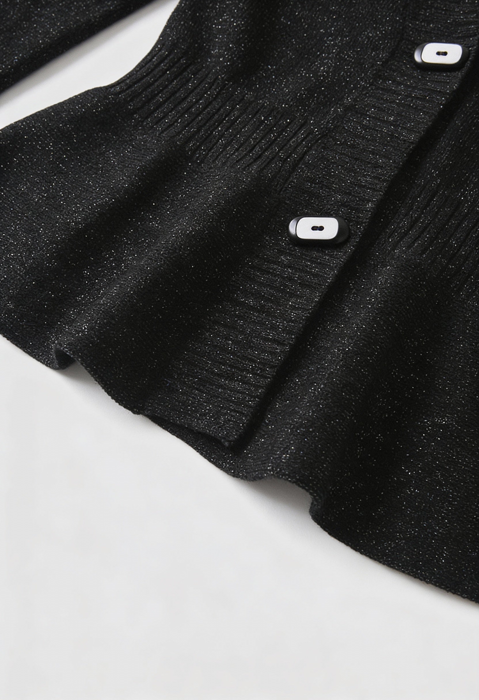 Victoria black cardigan sweater with open front design by Lumina Wear, shown on a hanger with a relaxed fit and soft knit fabric.