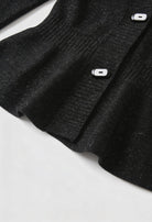 Victoria black cardigan sweater with open front design by Lumina Wear, shown on a hanger with a relaxed fit and soft knit fabric.
