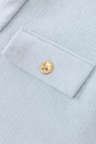 Light blue women's short jacket from Lumina Wear, stylish design with versatile look, perfect for casual and layered outfits.