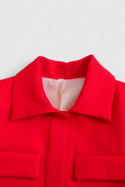 Red women's cropped button jacket from Lumina Wear with a trendy, flattering fit, perfect for stylish casual wear.