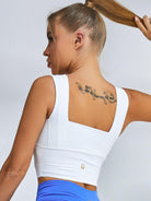 White Lumina Vancouver sports bra with wide shoulder straps, designed for comfortable support during workouts.