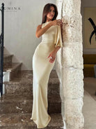 Off-white Yasmine knotted maxi dress by Lumina Vancouver, featuring a flowing design and elegant off-shoulder style.