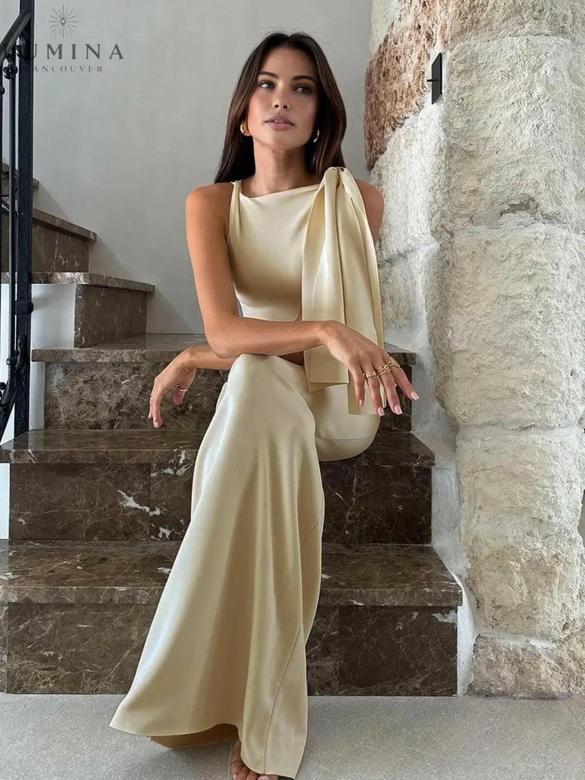 Off-white Yasmine knotted maxi dress by Lumina Wear, flowing fabric and elegant design, displayed on a model.