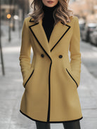 Lumina Wear Briony double-breasted white coat with trim, stylish and warm, displayed on a hanger.